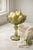 A charming mid-century pressed glass compote in a refined olive green hue, featuring an all-over floral motif and softly...