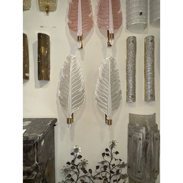 This listing features a pair of modern Murano glass leaf form sconces, frosted in a pearl white finish. The sconces are...
