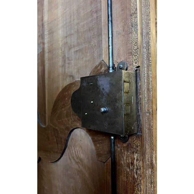 Louis xv style provençal wardrobe in solid walnut, 18th century it opens at the front with two doors it features a...