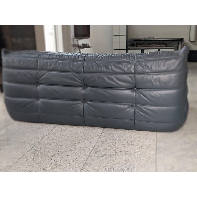 Authentic three-seater Togo sofa by Michael Ducaroy for Ligne Roset . Dark grey leather, has an attribution mark....