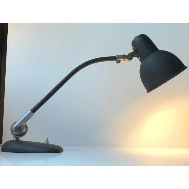 This black fully adjustable desk or table light from ASAS was manufactured in Denmark during the 1940s greatly inspired by...