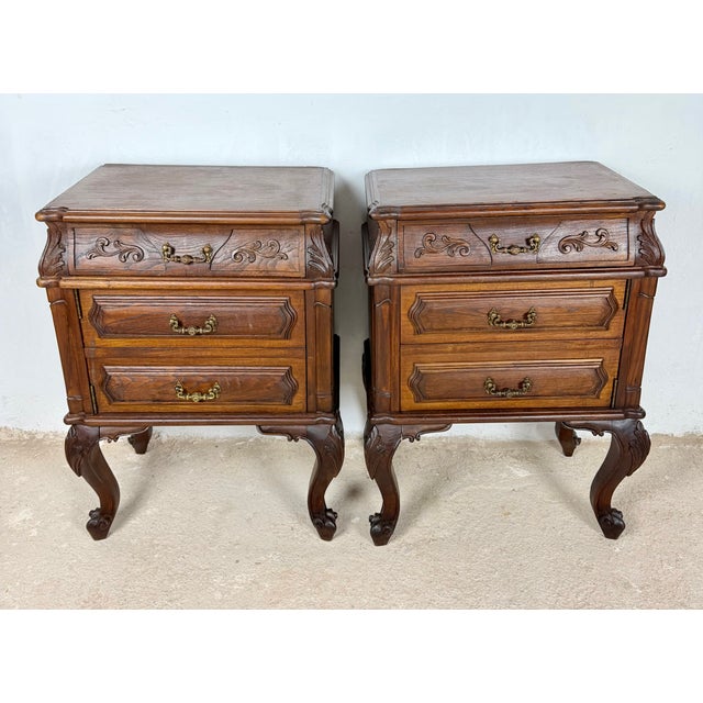 Elegant pair of French Louis XV style nightstands crafted in wood, each featuring three drawers with original brass...