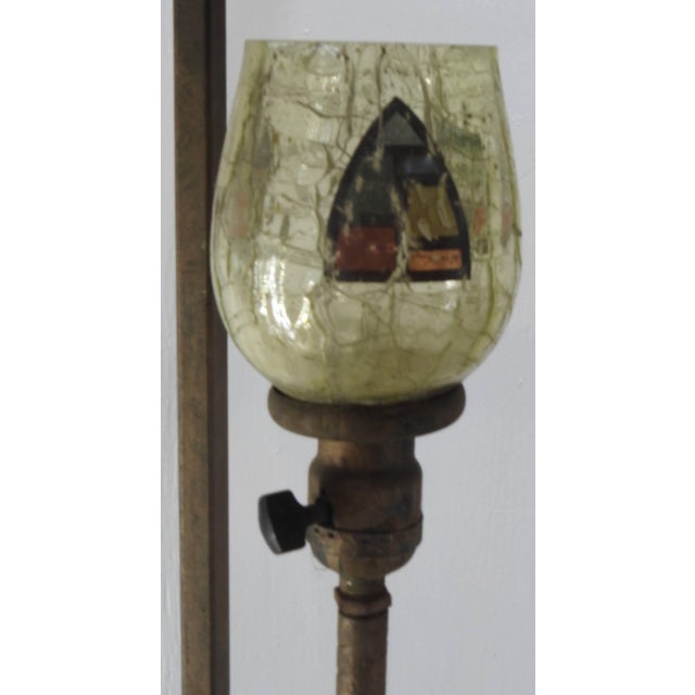 We are offering a unique lamp consisting of four arrows pointing upward. They surround a soft green crackle glass...