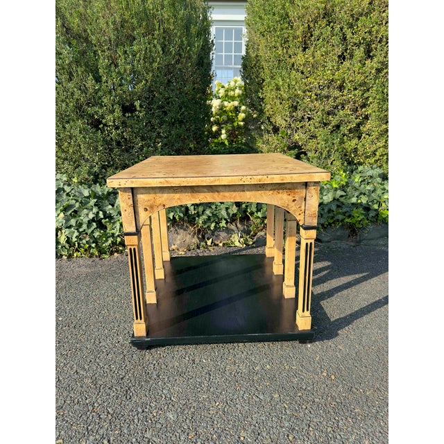 Fine ebonized burl wood side table in the neoclassical style. Eight fluted columns with hand-ebonized detailing gracefully...
