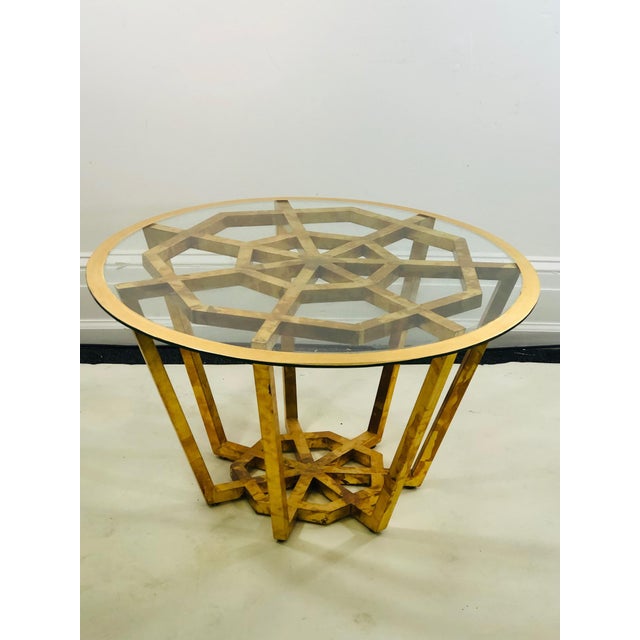 Accent table or center table in the manner of Jean Royere. Wood frame with glass top. Measures 18 1/2” high with 32”...