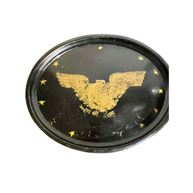 A striking early 20th-century American tole tray featuring a dramatic black lacquered ground adorned with a gilded...