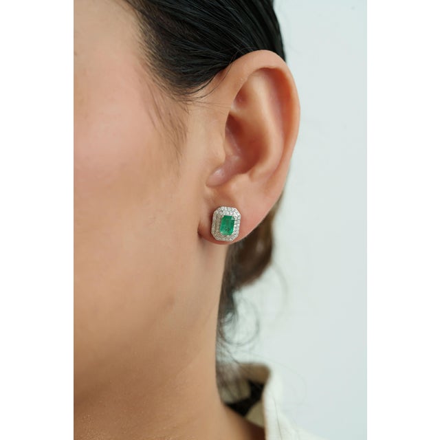 These elegant stud earrings showcase vibrant 1.3 carats of emeralds set in 14k white gold. Each emerald measuring 6.1 x...