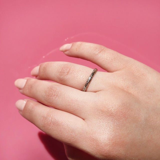 About This Ring: A delicate white gold band adorned with orange blossoms etched all the way around, a symbol of eternal...