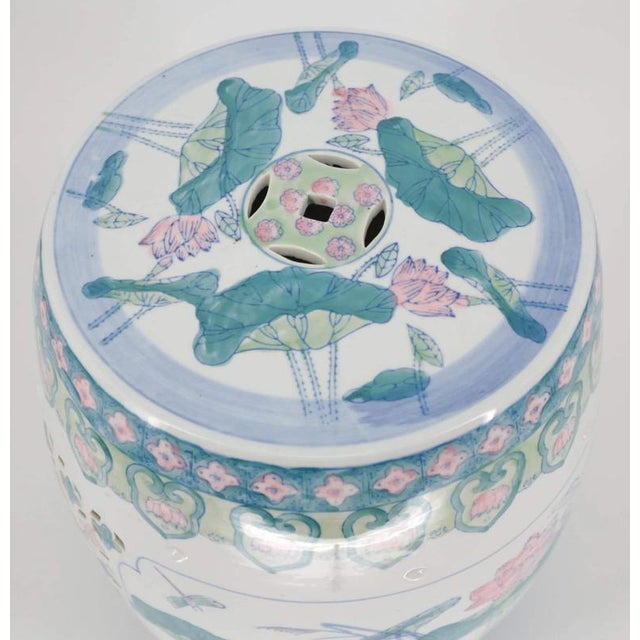 Hand-painted porcelain garden stool with Famille Verte decor. The painting is underglaze. The sides of the stool are cut...