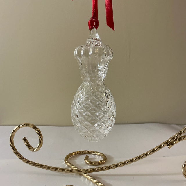 Made by the famed Steuben Glass Works of upstate New York in the early 21st Century, this glass ornament is deeply faceted...