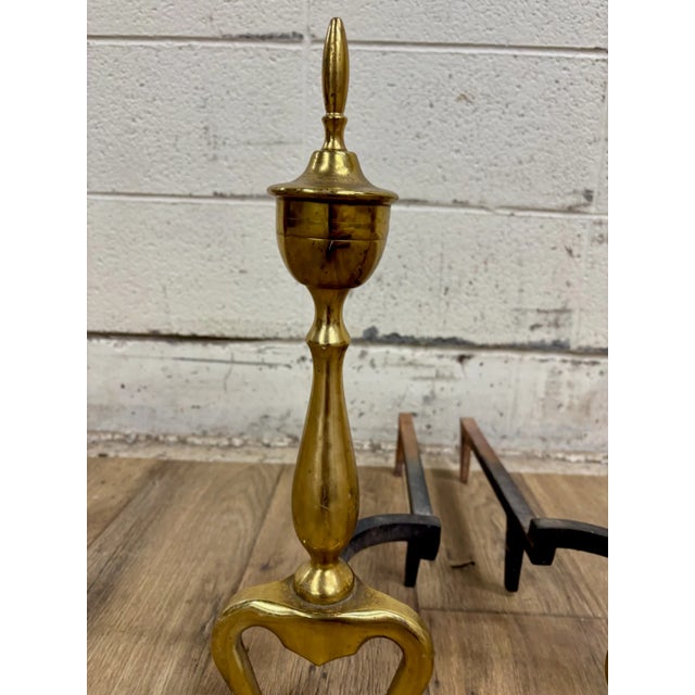 This is a stunning pair of vintage brass and iron andirons or fire dogs with claw feet. Dimensions: - 6.75 in wide - 17 in...