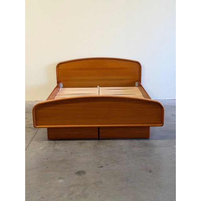 Beautiful Mid Century Modern queen size platform bed crafted in warm teak wood, featuring clean Scandinavian lines and...