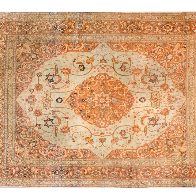 This early 20th-century Persian Hadji Jallili Tabriz rug, circa 1900, is a remarkable example of the refined artistry for...
