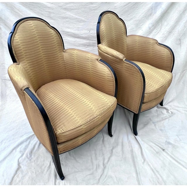 A stunning Pair of French Bergere Chairs in Style of Paul Follot. The pair have a beautiful scalloped back, a hand carved...