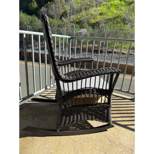 Late 19th century antique wicker rocking chair; base of and iron and wood. Chair is heavy, made so solidly and with such...