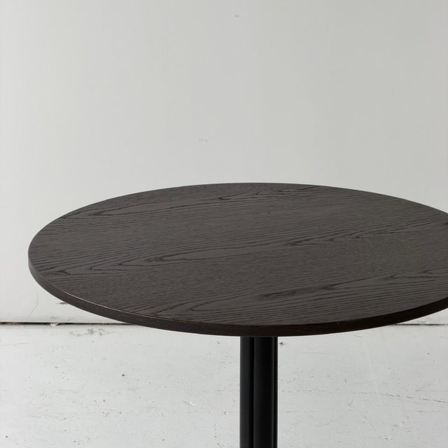 c. 2000s. Germany. Brown oak top with metal base.