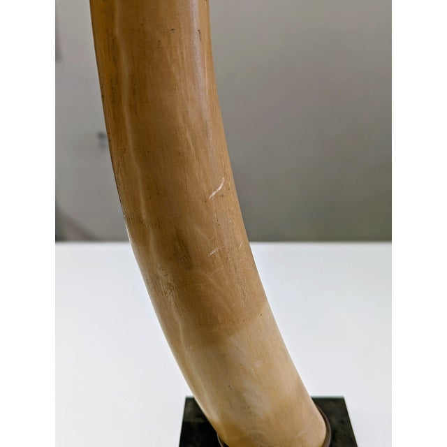 Large-scale faux tusk sculpture attributed to Chapman Manufacturing Co., featuring resin tusk mounted in brass collar on...