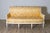 An elegant 18th-century French canapé, showcasing the refined craftsmanship and timeless style of the Louis XVI period....