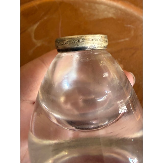 A beautiful pair of vintage glass shakers featuring sculptural sterling silver tops by renowned American silversmith Allan...