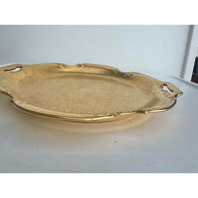 This is a Pickard China 24 karat gold floral pattern tray. This was used in a bathroom to display crystal perfume bottles....