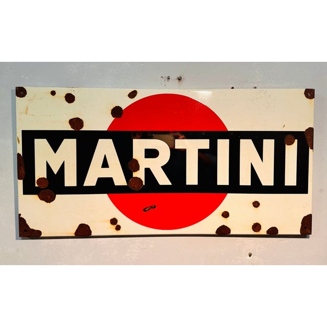 Old Martini sign with signs of wear on the enamel