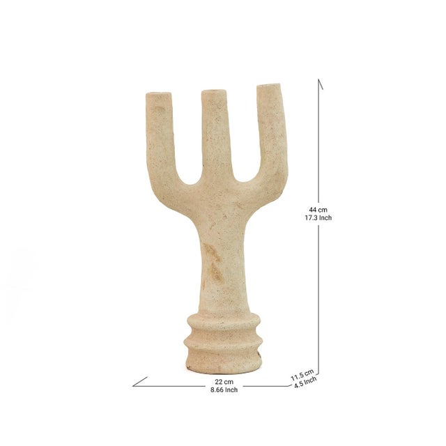 Three broad, flattened tines rise from a ringed pedestal in this Tamegroute sculpture, its bold trident silhouette echoing...