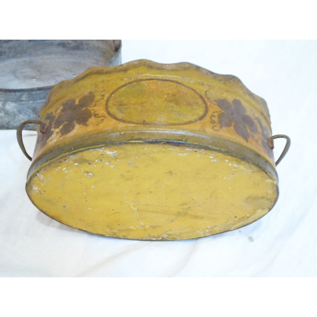 This French painted tole cache pot has a liner that you can plant in.