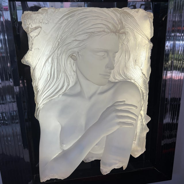 Acrylic sculpture of woman mounted on black background. Framed in black and backlit.(some dents on frame). From early...