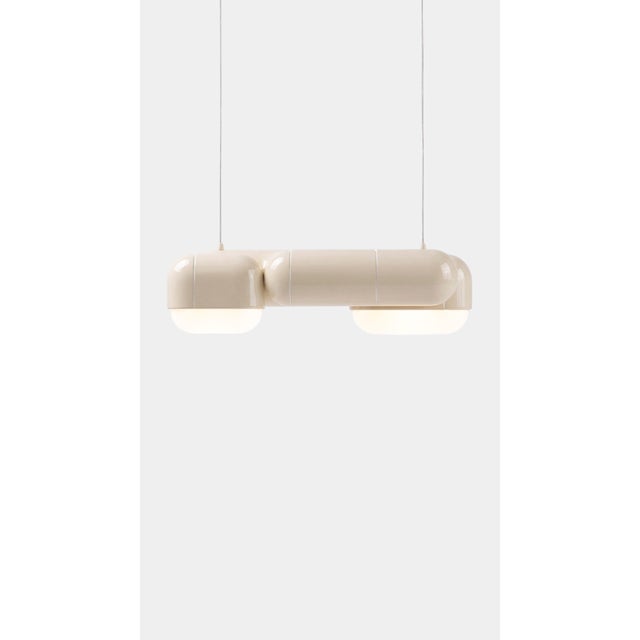 A pendant that changes with the day. In daylight its printed shell reads crisp and architectural, all shadow and ridge;...