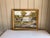 This painting is a beautiful scene of a garden with a glass greenhouse set in the middle of them. I love the details of...