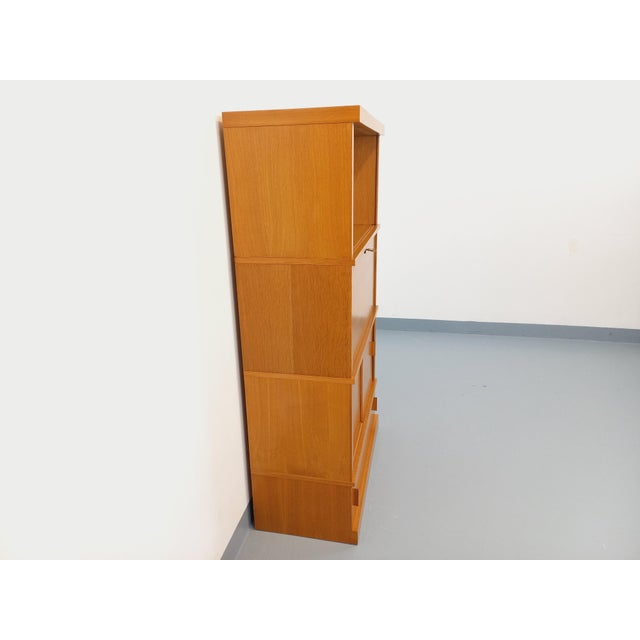 Vintage 1960s oak bookcase with a solid plinth, one open niche with a small removable shelf, one secretary section with a...