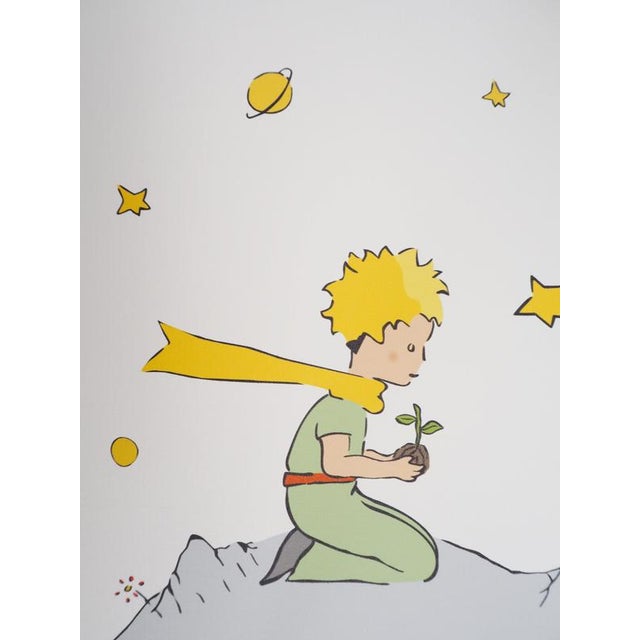 Antoine DE SAINT-EXUPERY (1900-1944) The Little Prince plants a flower on his asteroid Color photolithograph after the...