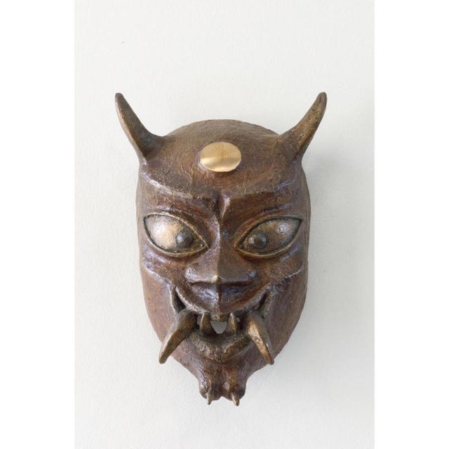 Bronze Oni Mask by Splady Art Studios Design by Alexander Yoshikawa Dimensions: W 11 x D 18 x H 25 cm. Materials: Bronze....