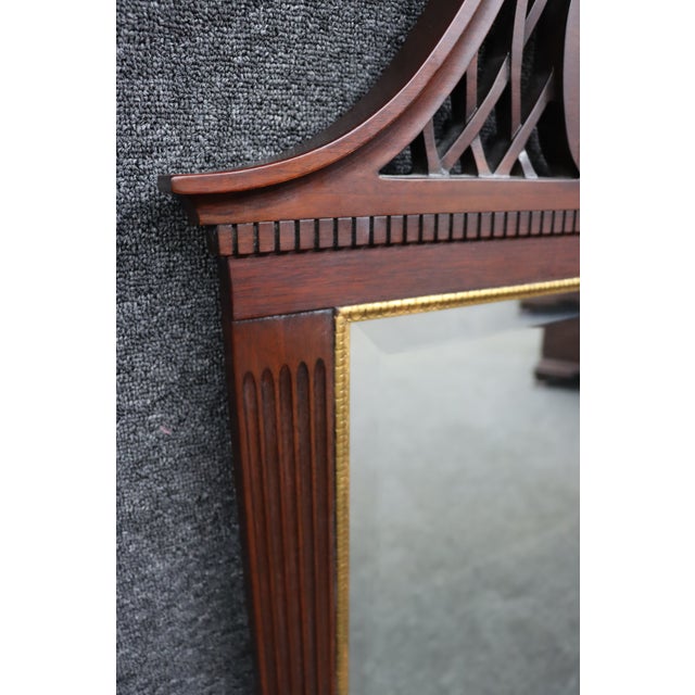 Henkel Harris Chippendale-style mahogany wall mirror, Model H-12, crafted in 2000. The mirror features an elaborate carved...