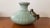 This is a Circa 1970 Chinese Celadon Porcelain Crab/Fishnet Pattern Vase. It measures 6 1/4" high and 7 1/2“ wide. The...