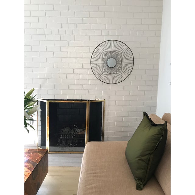 Basket-like, sculptural design with recessed round mirror at center. Simple yet dramatic, this piece is impactful by...