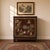 An artisan-crafted Qing dynasty style cabinetry adorned with carved figures and hand-painted landscapes against an oxblood...