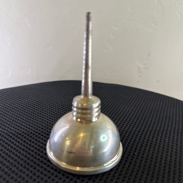 A striking blend of luxury and mechanical nostalgia, this midcentury sterling silver vermouth dropper by Tiffany & Co....