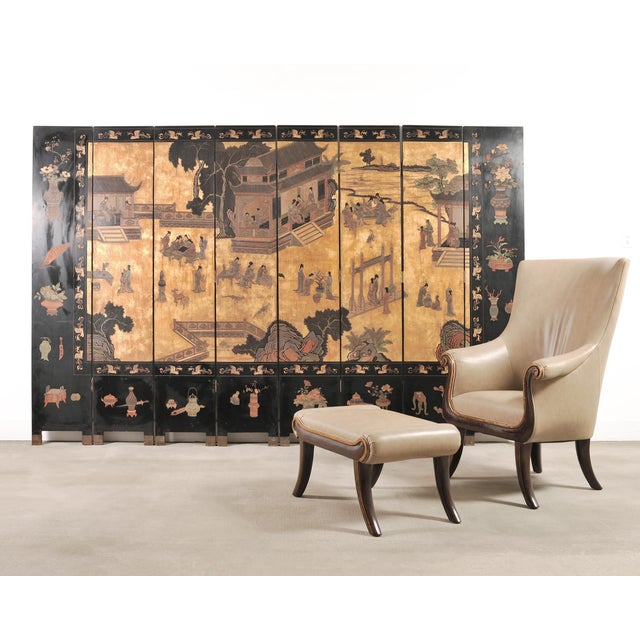 A large and highly decorative 20th century Chinese export eight-panel folding Coromandel screen executed in black lacquer...