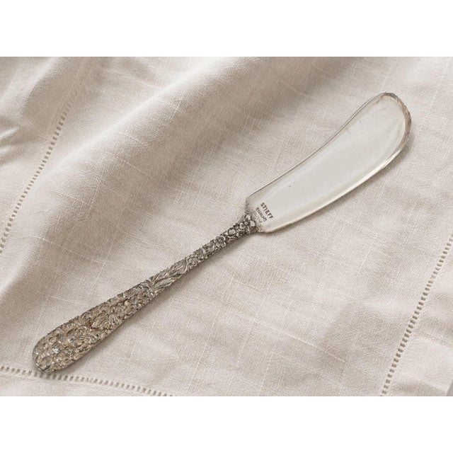 Mid 20th century Steiff Rose sterling silver butter knife with richly detailed floral handle decoration in the beloved...