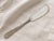 Mid 20th century Steiff Rose sterling silver butter knife with richly detailed floral handle decoration in the beloved...