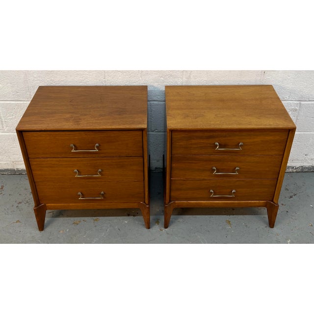 Enhance your bedroom with this pair of mid-century modern walnut nightstands, a perfect combination of refined design and...
