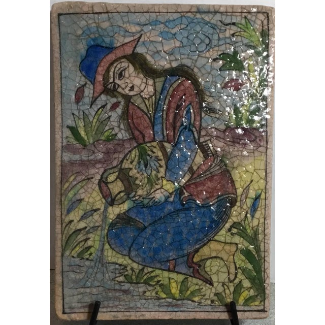 Exceptional Persian tile all hand-painted and glazed with garden scenery of a elagent looking woman watering her garden....
