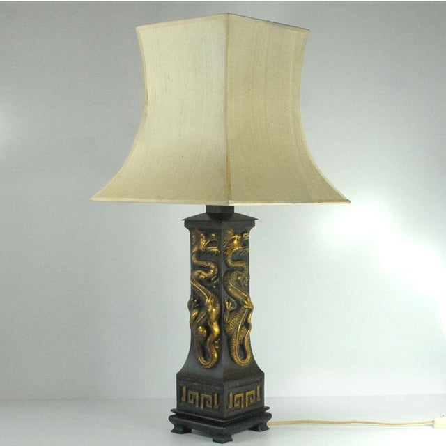 A large, highly decorative table lamp in an oriental style. It is made of patinated and locally gilded metal and sits on a...