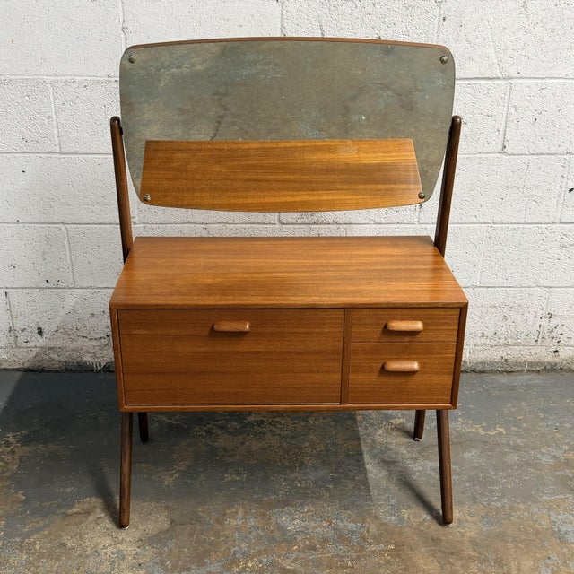 This Danish teak dressing table or vanity has a great compact form and a very practical layout. The design is simple and...