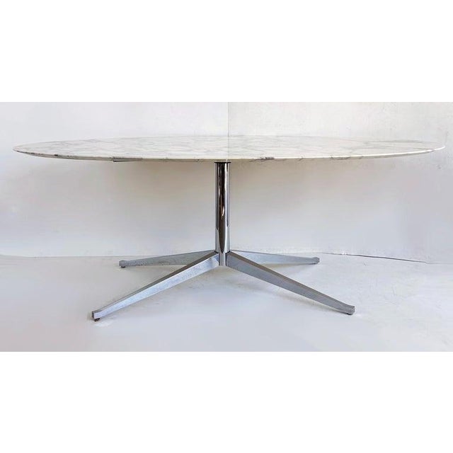 Florence Knoll Oval Carrara Marble Dining Table, Signed Stainless Steel Base Offered for sale is a Florence Knoll...