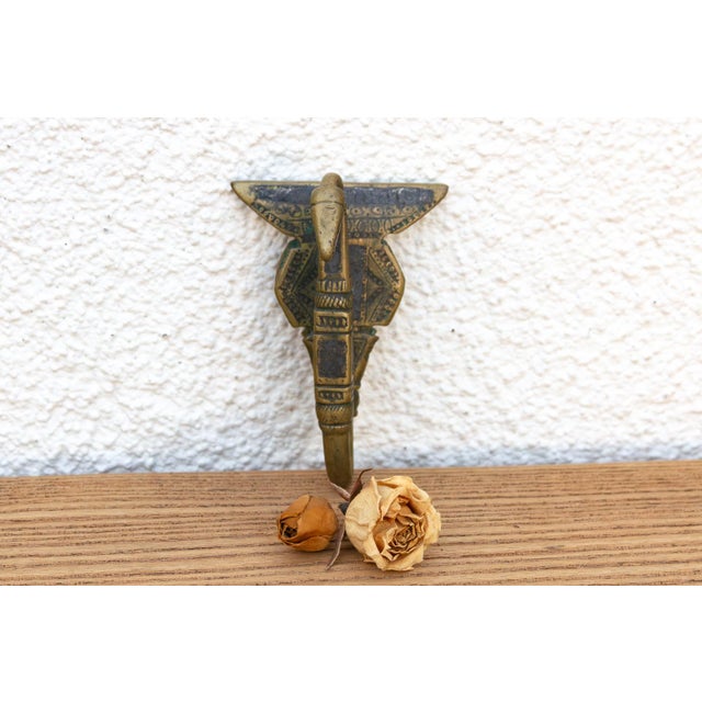 A robust utilitarian antiquity featuring a detailed geometric stem and a stylized architectural bud finial, carrying a...
