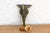 A robust utilitarian antiquity featuring a detailed geometric stem and a stylized architectural bud finial, carrying a...