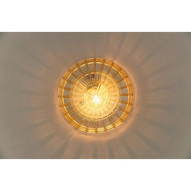 Pair of Spoke Wheel Flush Mounts in Amber Glass, 1960s Dimensions Height: 4.33 in. (11 cm) Width: 9.84 in. (25 cm) The...