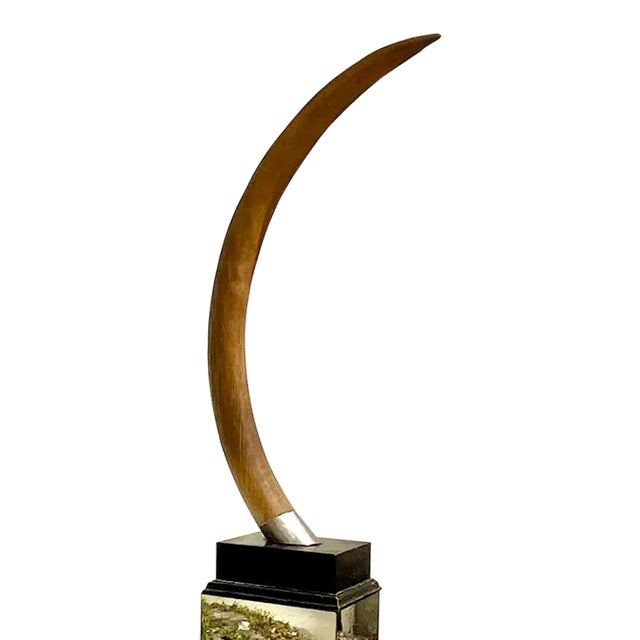 An exceptional vintage faux elephant tusk sculpture, beautifully rendered with graceful curvature and impressive scale....